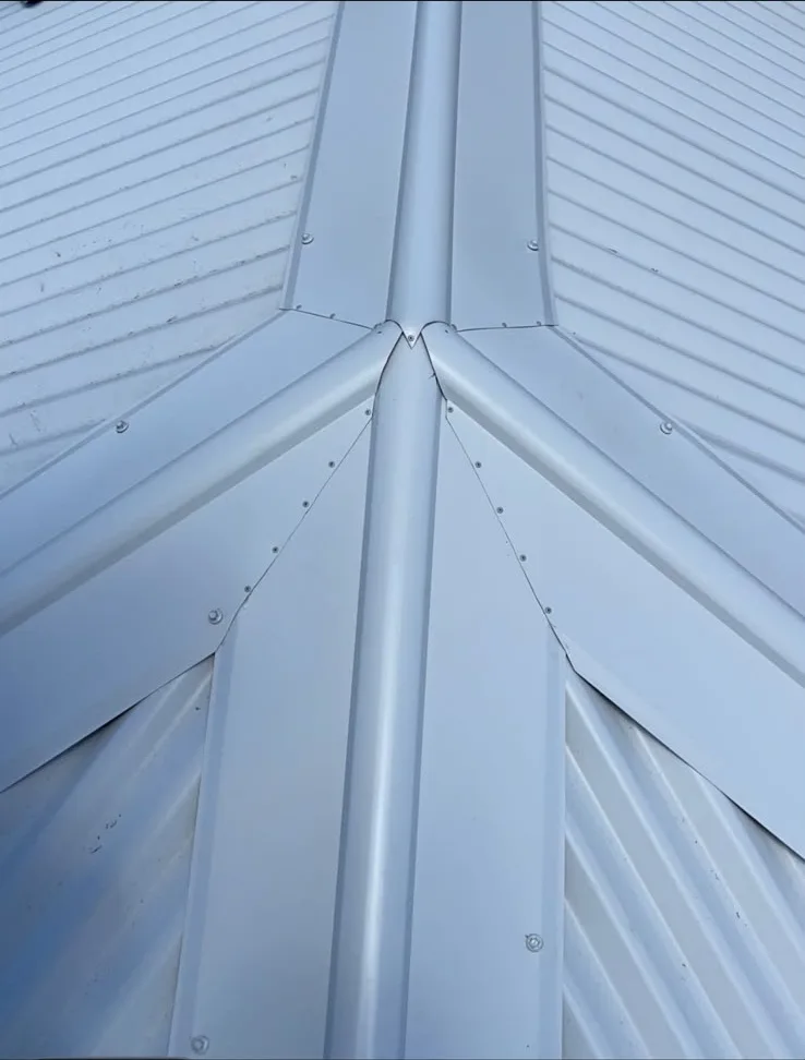 Close-up of Colorbond ridge capping where three roof planes meet
